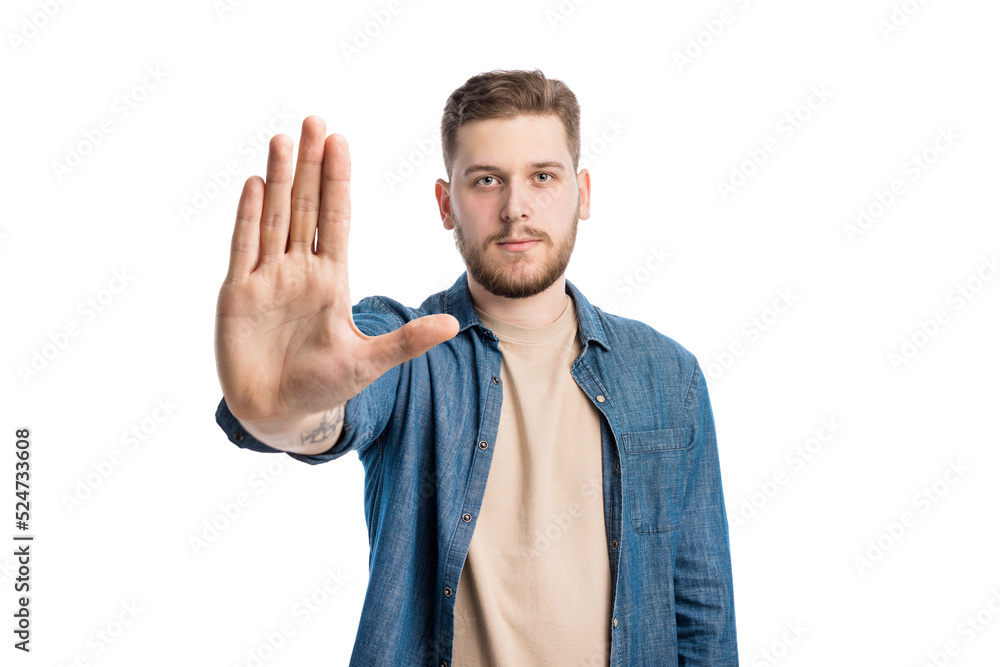 Serious caucasian guy posing with outstretched hand and giving stop signal. Bearded confident man pulling arm towards camera over white studio background. Serious caucasian guy posing with outstretched hand and giving stop signal. Bearded confident man pulling arm towards camera over white studio background.