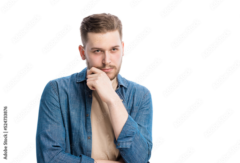 Smart pensive male person touching his chin and thinking while making choice. Thoughtful caucasian man pondering on important decision in studio.