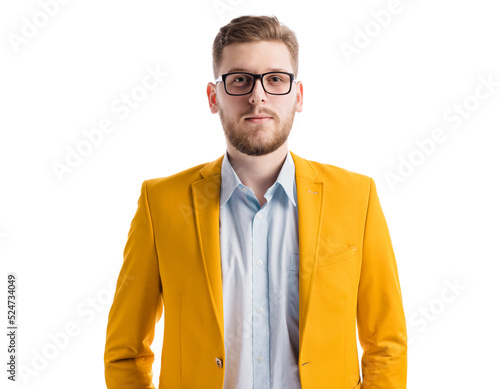 Portrait of confident young man with beard in stylish yellow jacket standing in studio. Portrait of self assured caucasian businessman looking trustworthy and sincerely over white background.