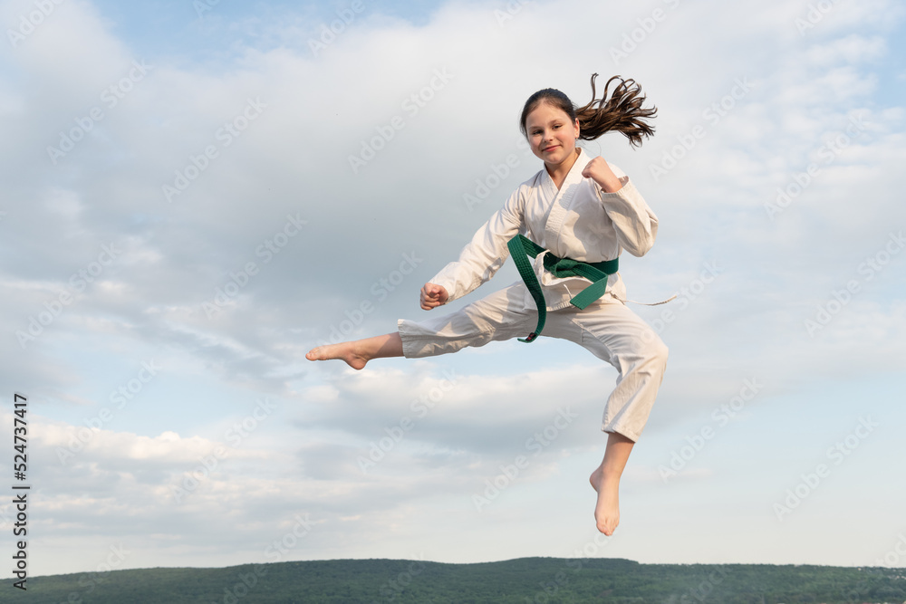 judo concept. teen girl practicing judo. girl judo fighter on sky background judo concept. teen girl practicing judo. girl judo fighter on sky background