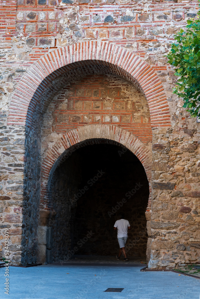 Door in the high wall under the clock tower in Buitrago de Lozoya, Madrid.