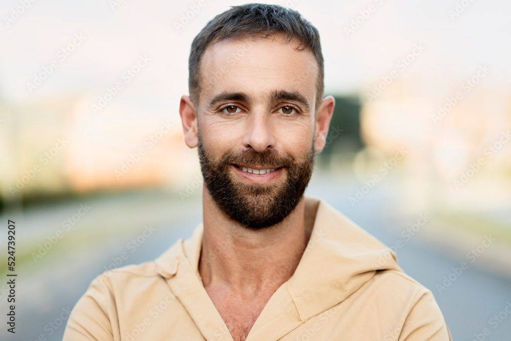 Authentic portrait of handsome smiling latin man wearing casual clothing looking at camera on the street Authentic portrait of handsome smiling latin man wearing casual clothing looking at camera on the street