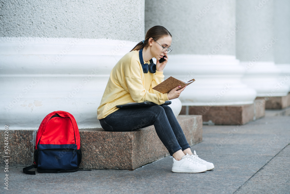 Time Management For Students, Student schedule, college students manage their day. Outdoor portrait of girl with laptop, papers and books near college, university