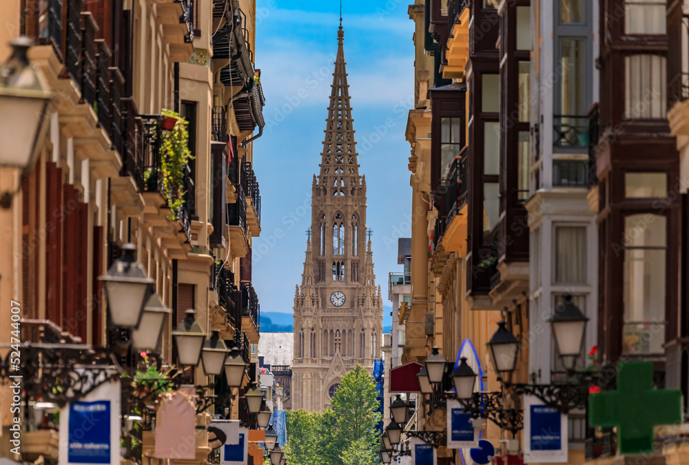 View along a street in old town onto Good Shepherd of San Sebastian cathedral in Gothic Revival with a 75 m spire in Donostia, Basque Country, Spain