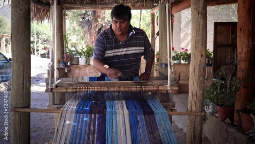 textile hispanic weaver craftsman making products on a wooden handicraft loom