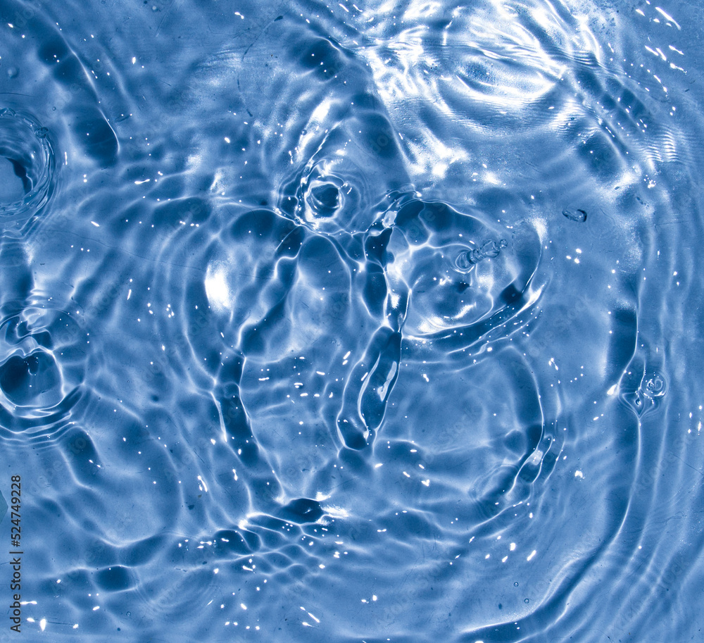 Flow of water is pouring on rippled water surface. Abstract background. Copy space for your design - stock photo Flow of water is pouring on rippled water surface. Abstract background. Copy space for your design - stock photo