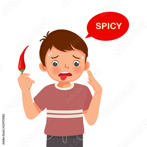 cute little boy holding red chili pepper showing spicy taste of tongue five senses