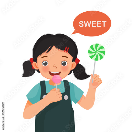cute little girl holding lollipop candy showing sweet taste of tongue five senses
