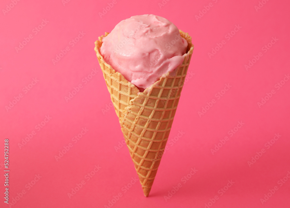 Delicious ice cream in waffle cone on pink background Delicious ice cream in waffle cone on pink background