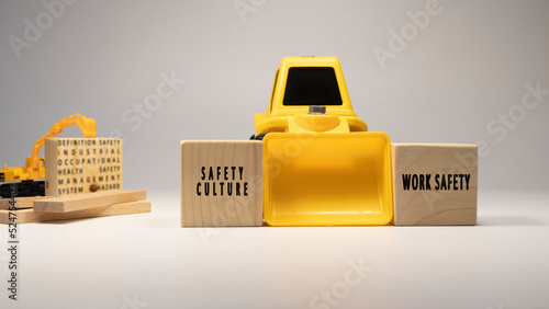 Safety culture, work safety , written on wooden sticks. Business machine and white background concept. Occupational safety and industry
