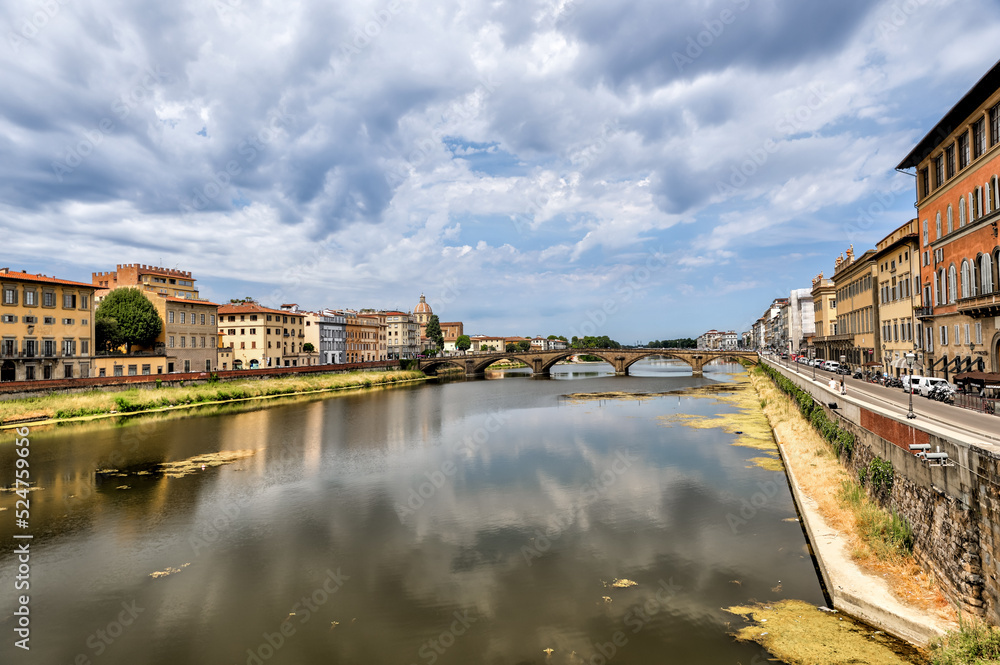 Views of the St Trinity Bridge and Ponte Vecchio along the Arno River in Florence Italy