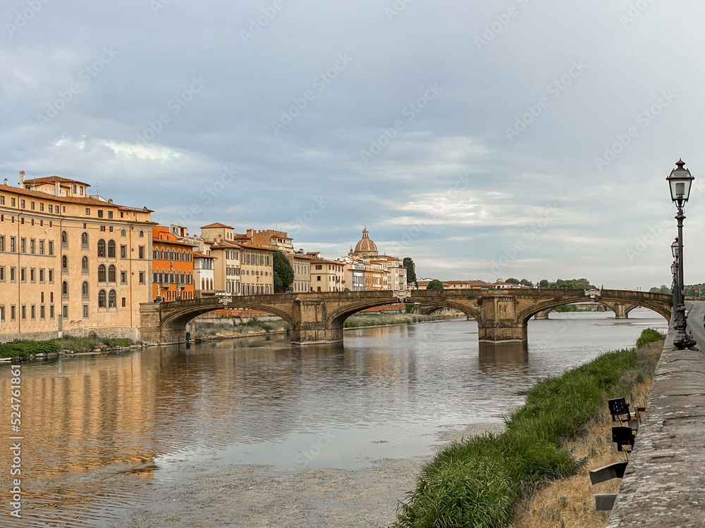 Fototapeta premium Views of the St Trinity Bridge and Ponte Vecchio along the Arno River in Florence Italy