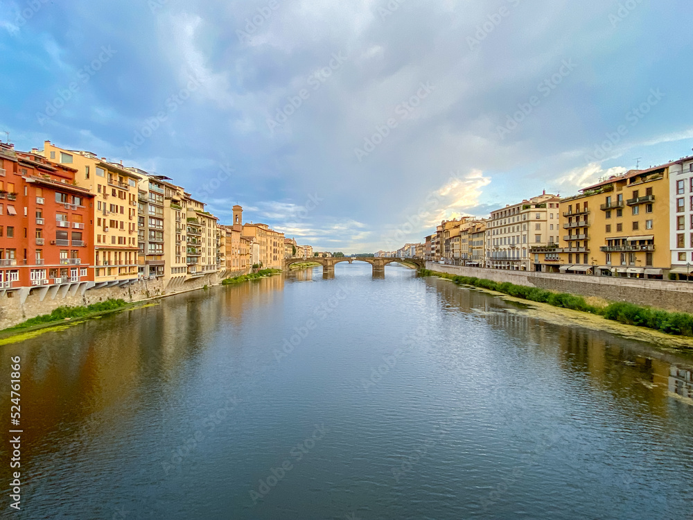 Views of the St Trinity Bridge and Ponte Vecchio along the Arno River in Florence Italy