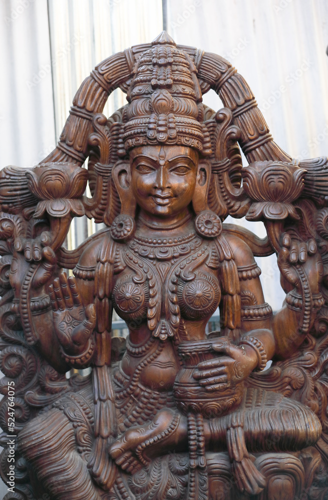 Wooden statue of Hindu Goddess Lakshmi Wooden statue of Hindu Goddess Lakshmi