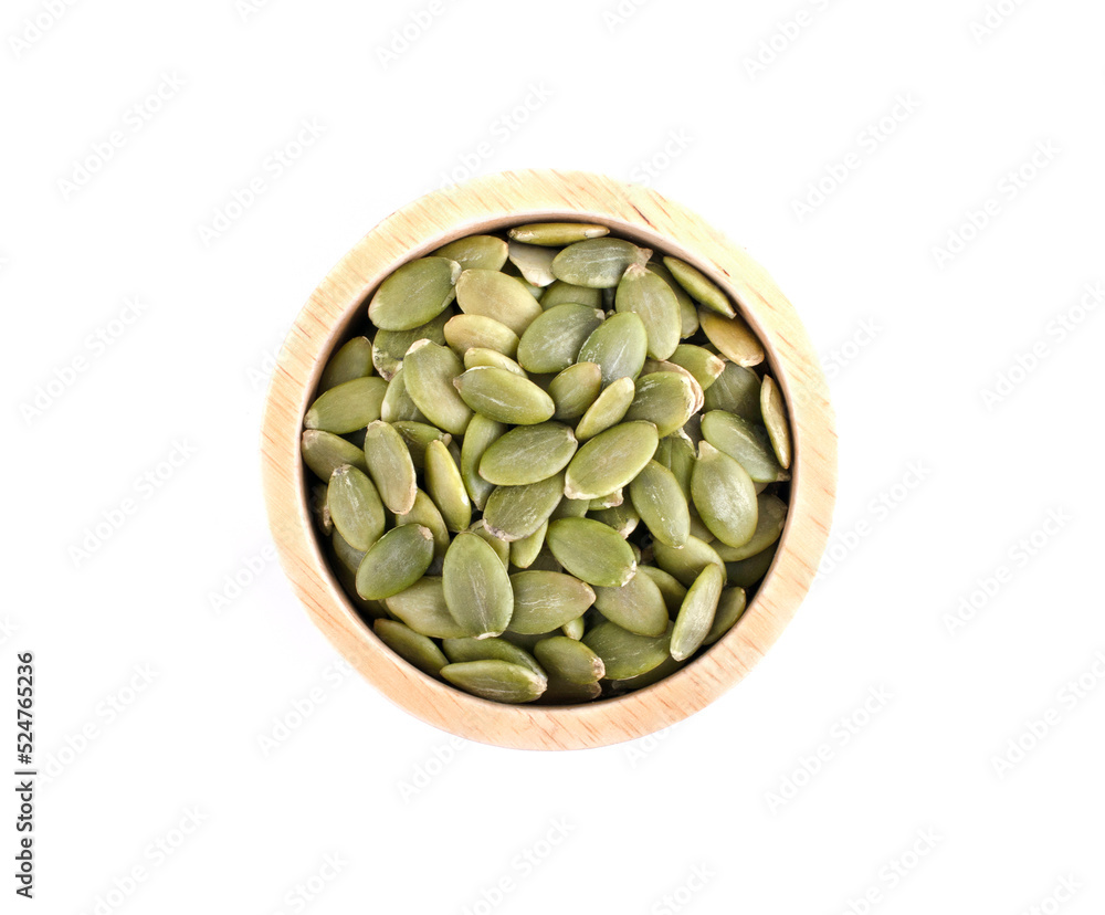 pumpkin seeds in wooden bowl isolated on white background. pumpkin seeds in wooden bowl isolated on white background.