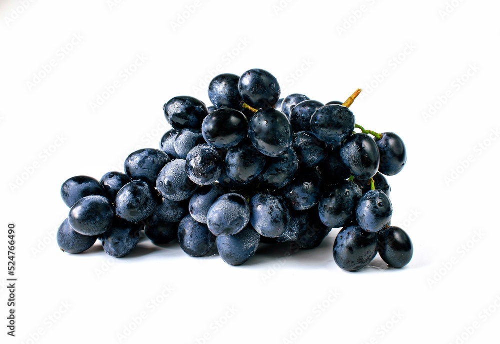 Big bunch of sweet black grapes isolated on white background. Big bunch of sweet black grapes isolated on white background.