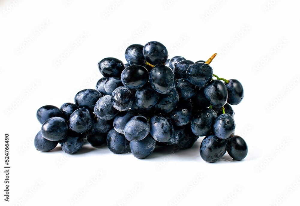 Big bunch of sweet black grapes isolated on white background.