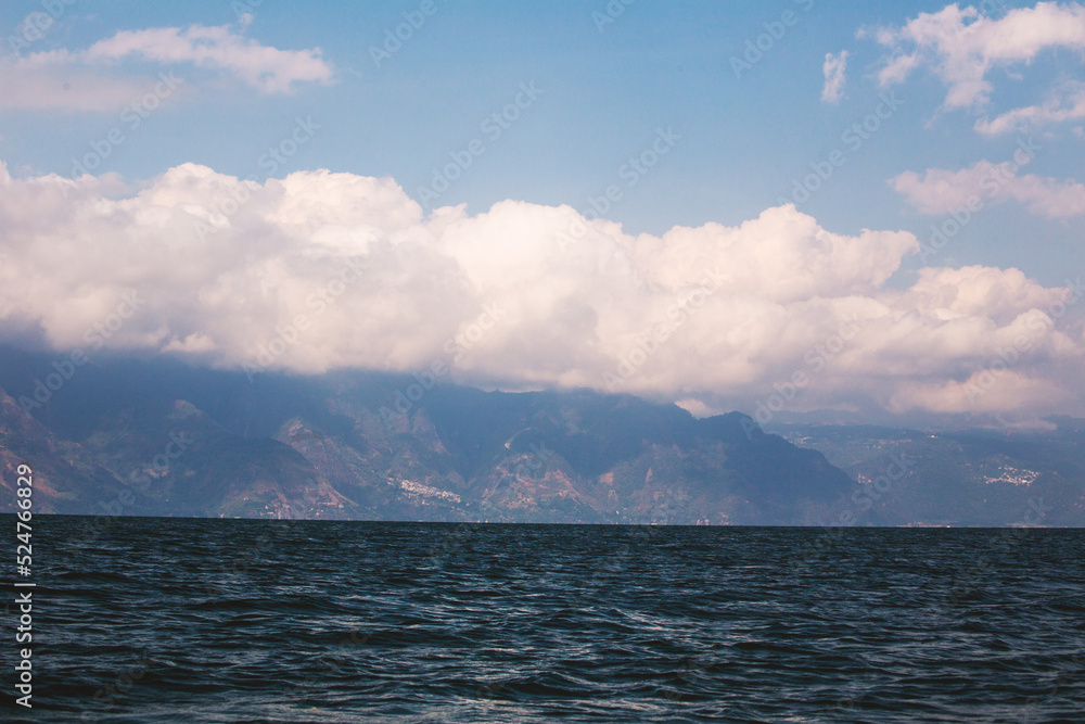 Clouds over mountains and river
