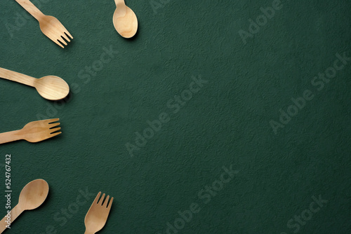 Plastic free set bamboo spoon and fork on dark green background.Zero waste disposable kitchen ware