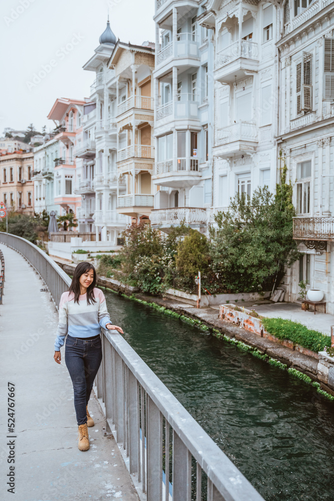woman walking through beautiful area in istanbul with beautiful colorful building