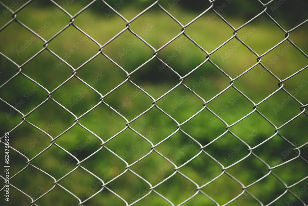 Chain link fence with blurred background : demarcation concept Chain link fence with blurred background : demarcation concept