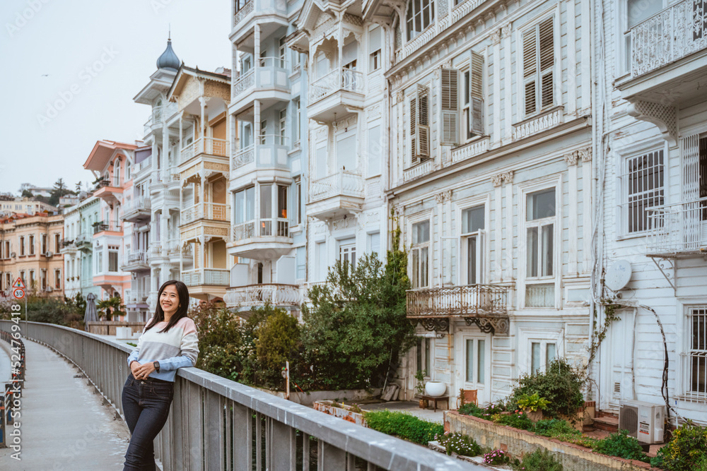 beautiful woman exploring bebek bosphorus area enjoying the beauty of historical building in arnavutkoy