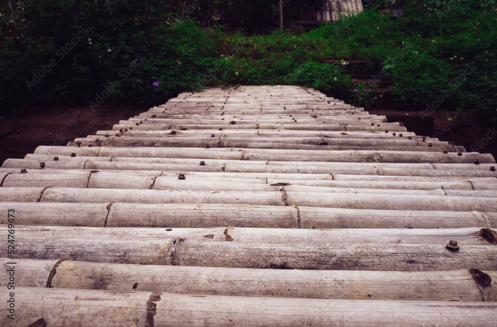 An ancient bamboo bridge connected to cross the canal river. An ancient bamboo bridge connected to cross the canal river.