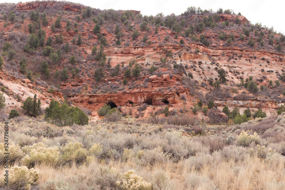 Rock caves in high dessert hillside, red rocks land, four corners area