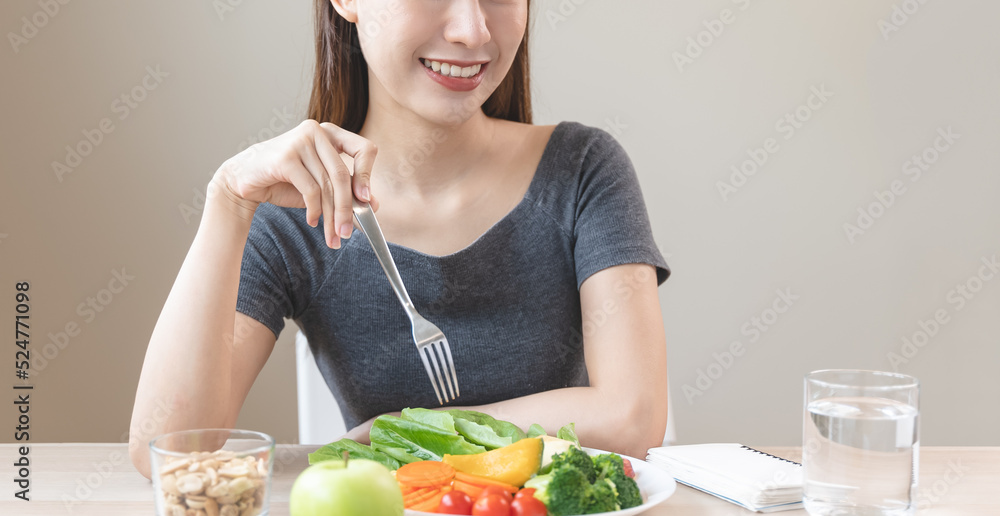 Asian females eating salad as breakfast for good health Asian females eating salad as breakfast for good health