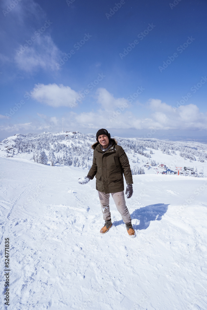 portrait of a man walking on top of the snowy mountain in bursa turkey
