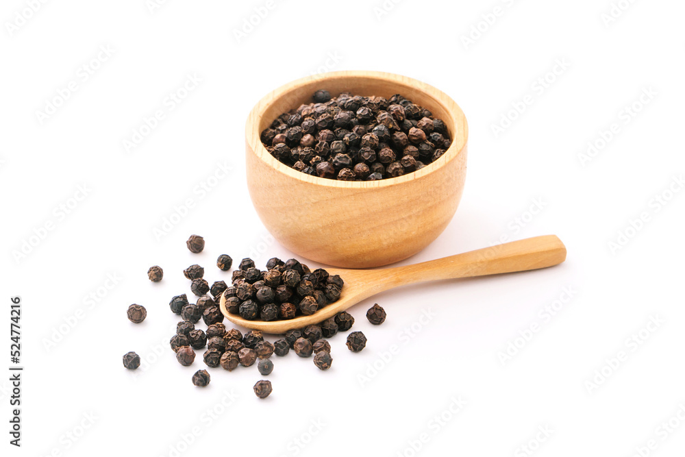 Black pepper corn in wooden spoon with bowl isolated on white background.