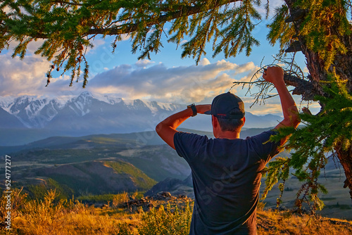 a man looking at the mountains