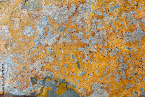 Colorful stone surface with yellow, orange and gray coloring