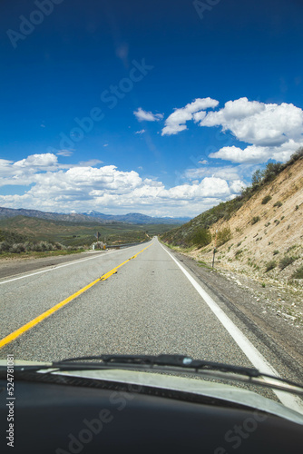 Road with bright blue sky and clouds