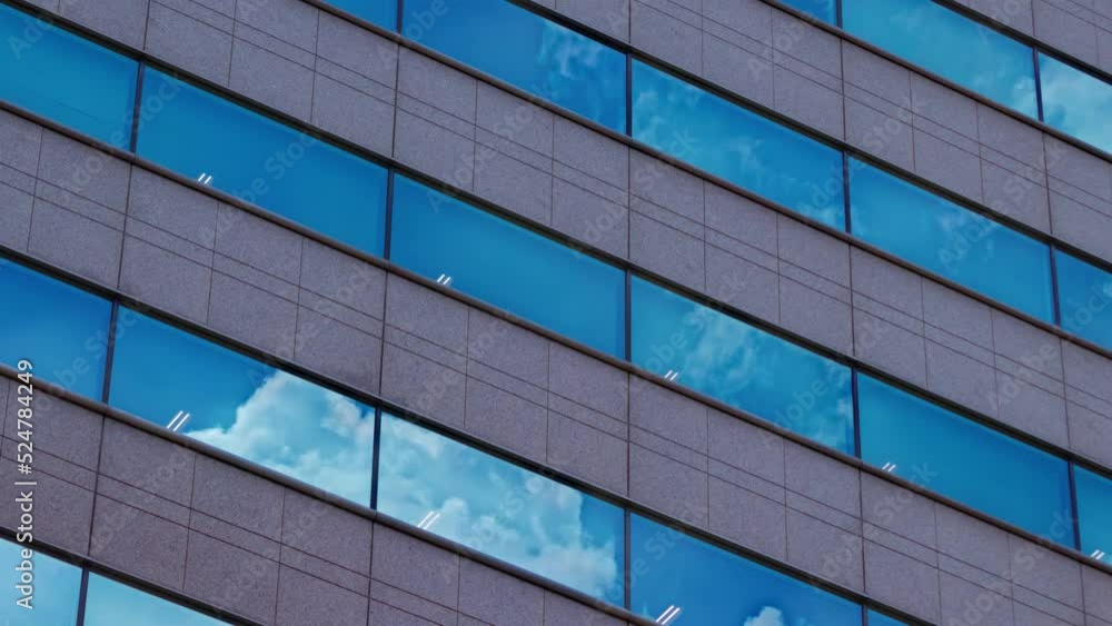 A timelapse of cloud reflecting the building in the business town long shot panning A timelapse of cloud reflecting the building in the business town long shot panning