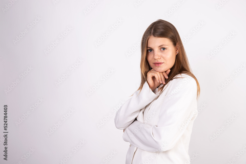 Portrait of young confident businesswoman looking at camera. Caucasian girl wearing white jacket standing over white background. Businesswoman concept Portrait of young confident businesswoman looking at camera. Caucasian girl wearing white jacket standing over white background. Businesswoman concept