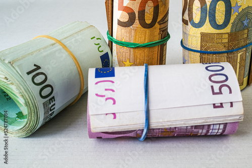 Cash Money Rolls on a Table. rolls of Euro bills with rubber bands. Business, success and commercial activity photo