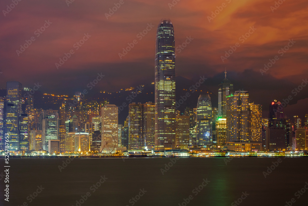 Fototapeta premium Hong Kong from Victoria Harbor. Business building from Victoria harbour at dusk. Landscape of Hong Kong city with laser show from modern high building in business district area.