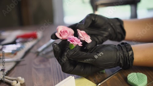 Artisan shows finished polymer clay flowers. Handmade and hobby concept.