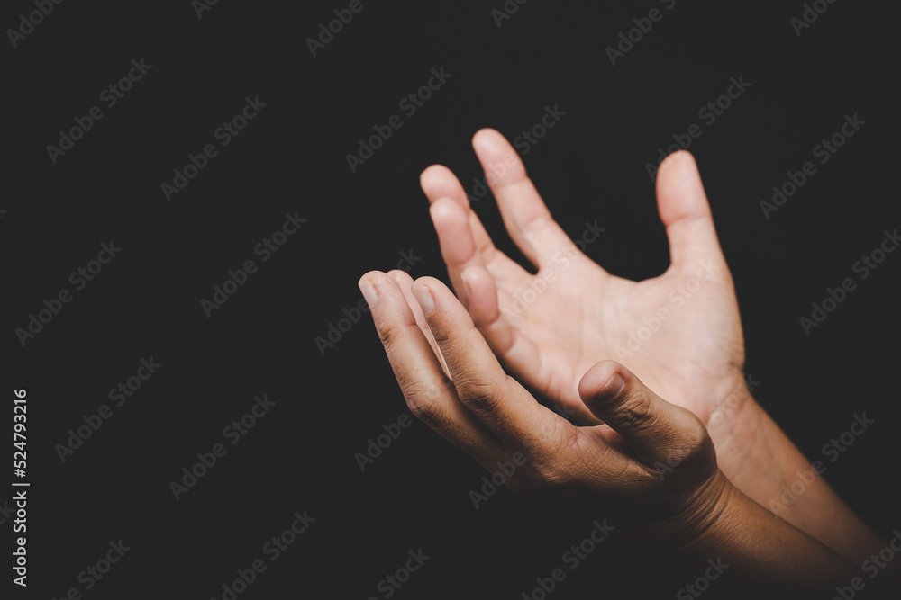 Close up Asian christian woman hands person pray and worship for thank god in church with black background, The concept for faith, spirituality and religion Close up Asian christian woman hands person pray and worship for thank god in church with black background, The concept for faith, spirituality and religion