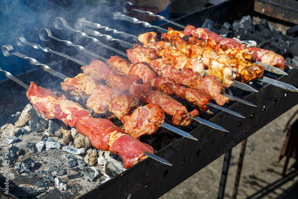The meat is cooked on the grill. The process of cooking barbecue on coals.