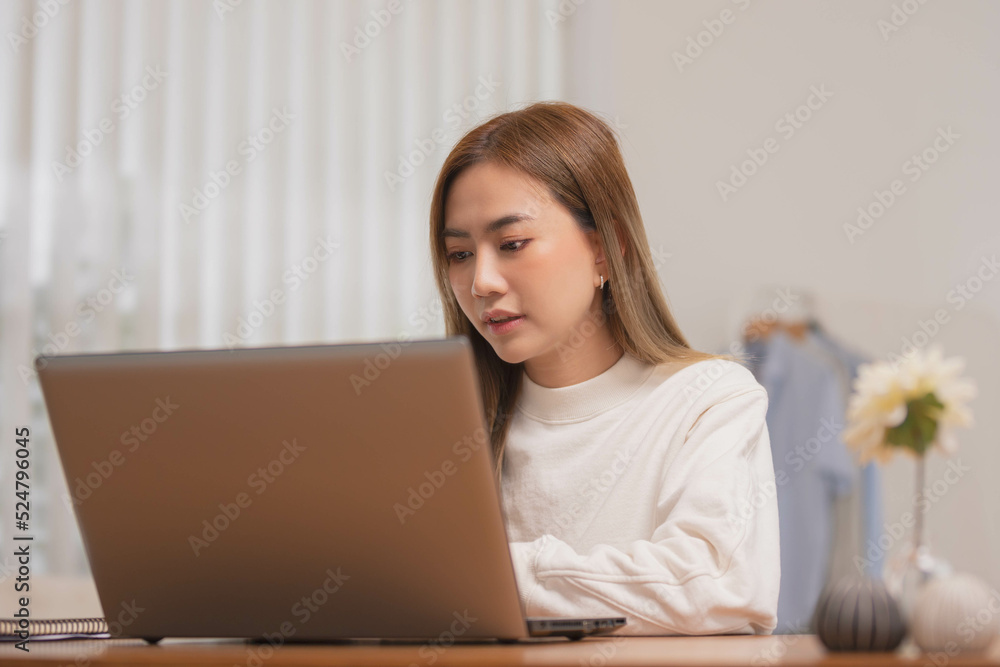 Asian girl using computer laptop playing game and social media or chatting with her friends. Asian girl using computer laptop playing game and social media or chatting with her friends.