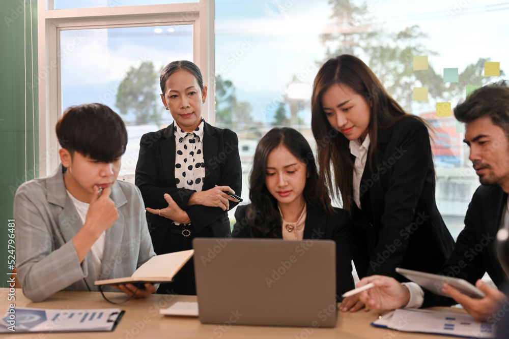 Focus on Senior old aged businesswoman meeting with business team, Diversity aged business people working together. Focus on Senior old aged businesswoman meeting with business team, Diversity aged business people working together.