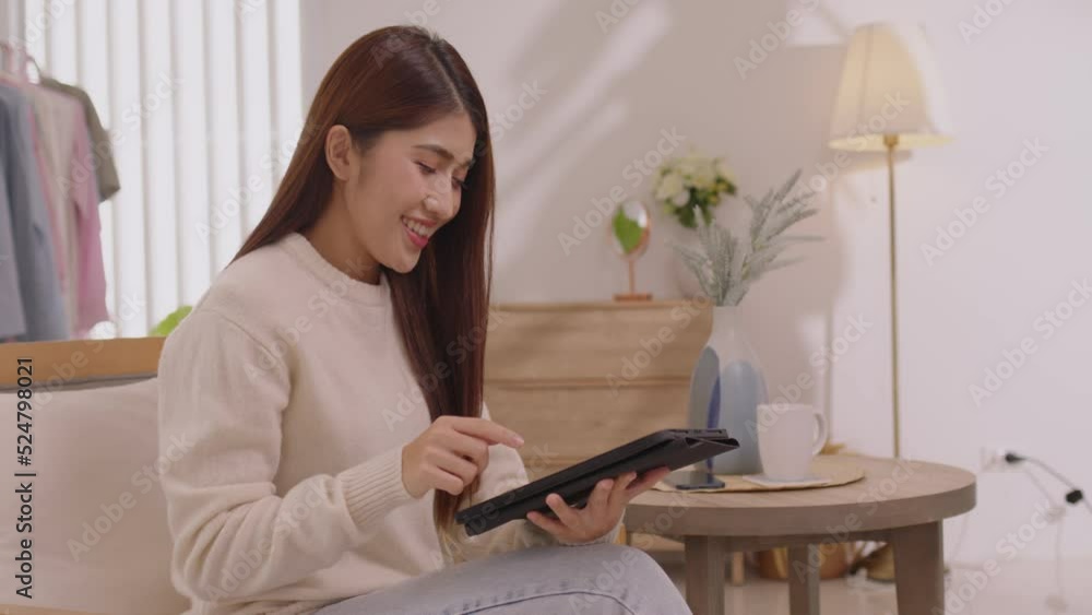 Asian girl using tablet playing game and social media or chatting with her friends. Asian girl using tablet playing game and social media or chatting with her friends.