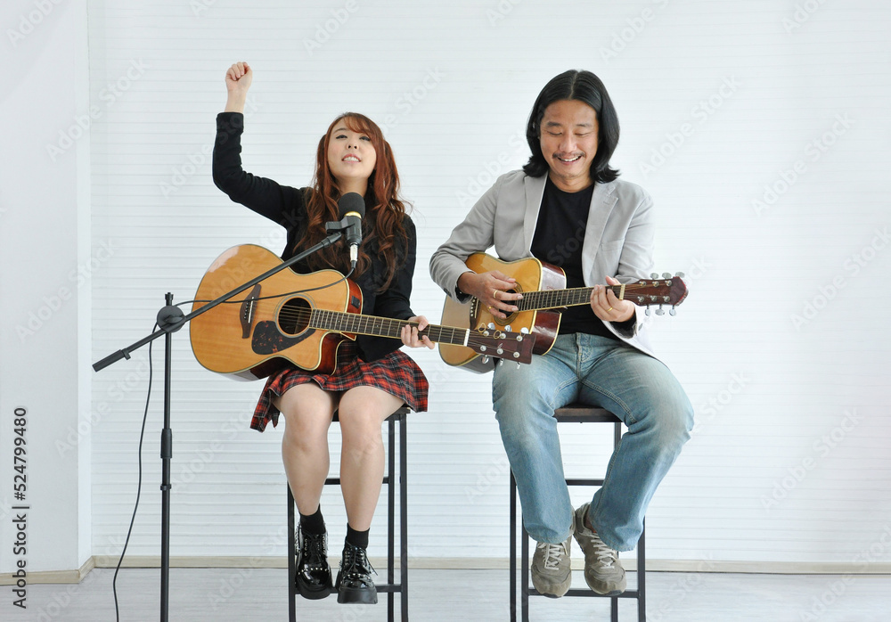 joyful duo artist playing guitar in music academy and a girl hand up for cheer up spectator concert joyful duo artist playing guitar in music academy and a girl hand up for cheer up spectator concert