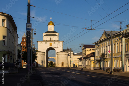 Vladimir, Russia - August, 16, 2022: facade of the old white stone golden Gate in the historical center of the city on a sunny summer day