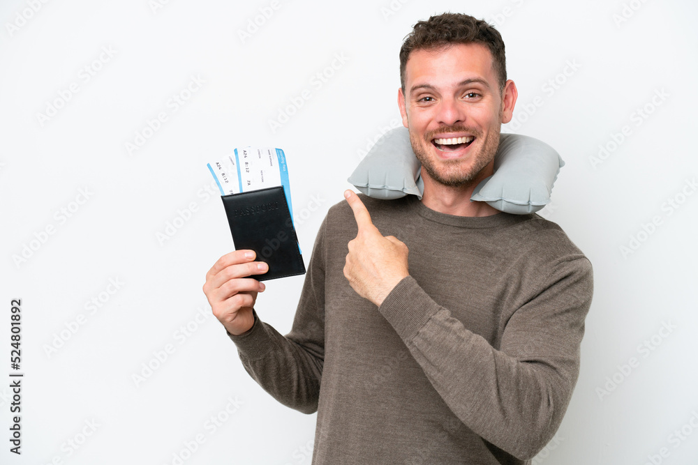 Young caucasian man holding a passport isolated on white background pointing back Young caucasian man holding a passport isolated on white background pointing back