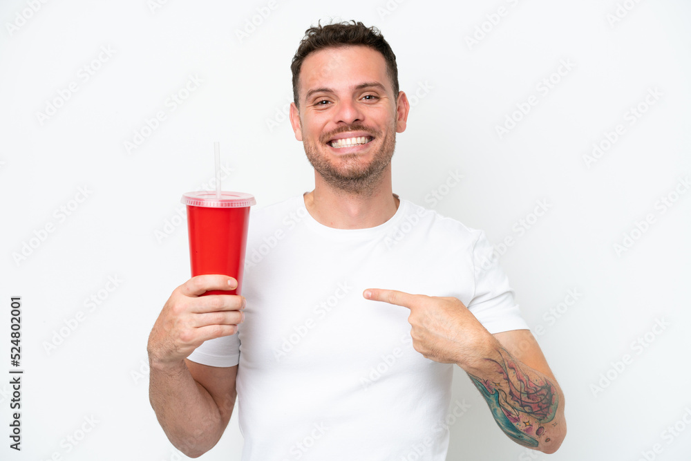 Young caucasian soda holding soda isolated on white background with surprise facial expression Young caucasian soda holding soda isolated on white background with surprise facial expression