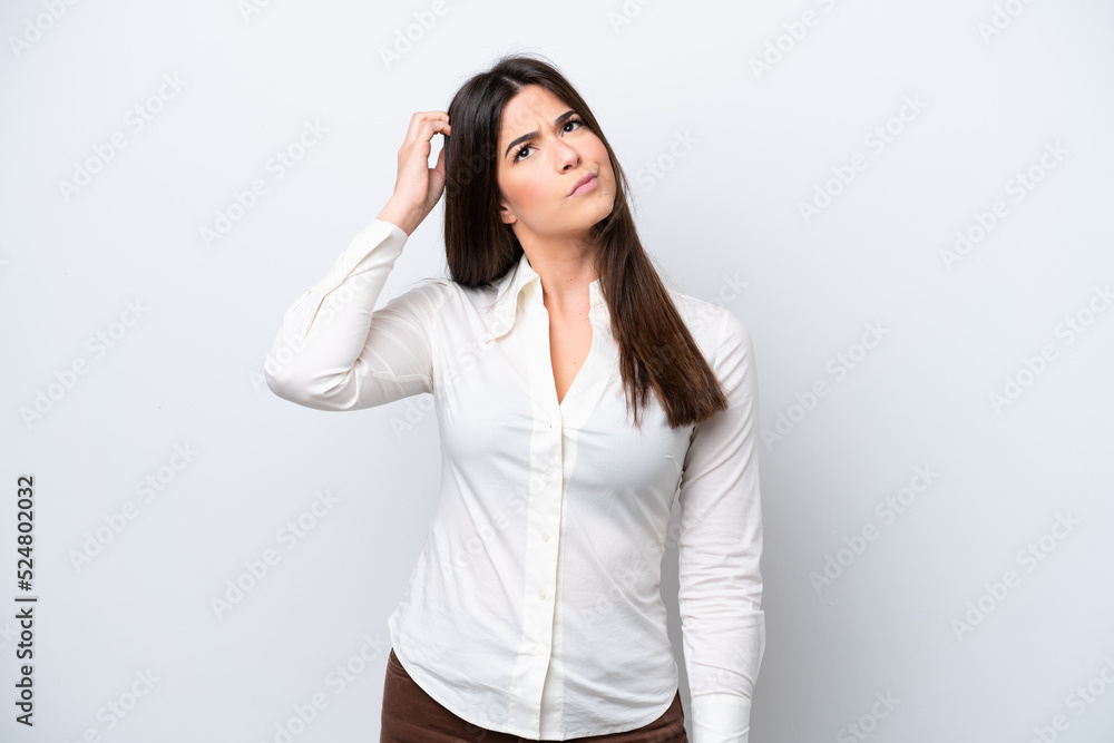 Young Brazilian woman isolated on white background having doubts while scratching head