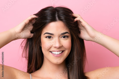Young Brazilian woman isolated on pink background . Portrait